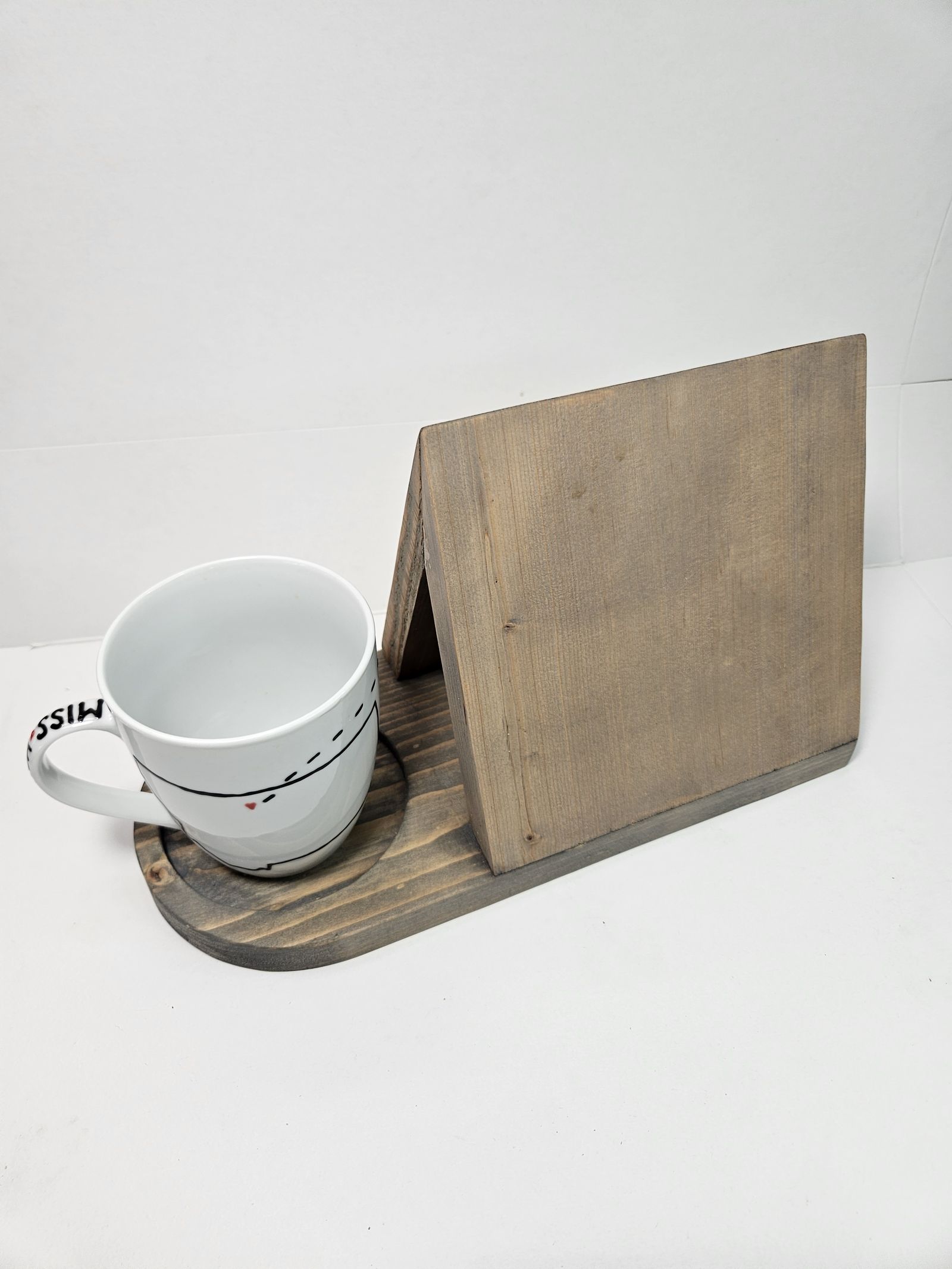 Wooden book and mug stand on a table