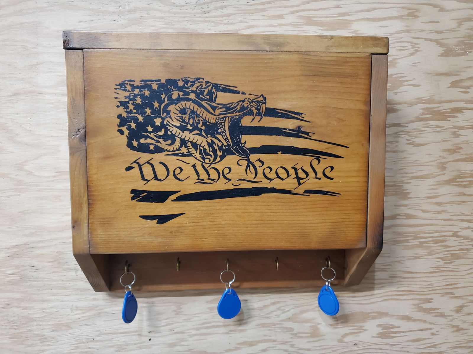Wooden key holder engraved with a flag and the words We the People