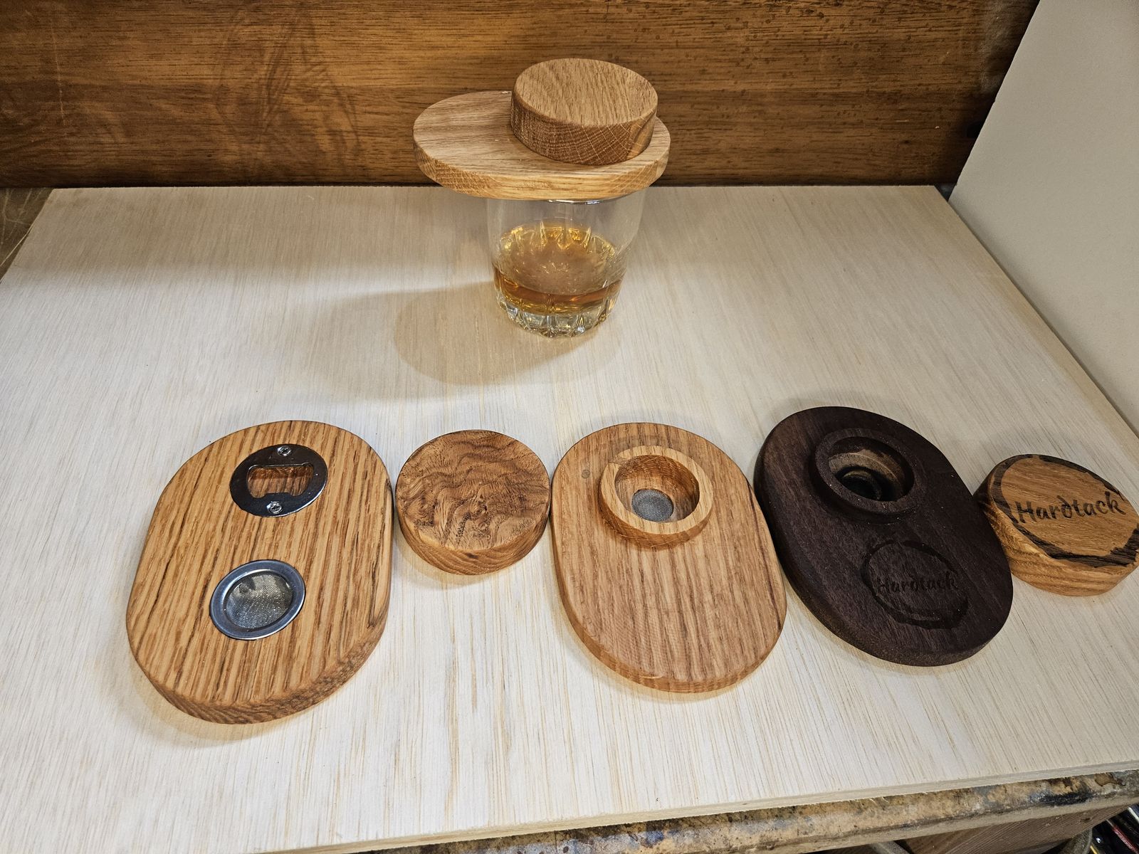 Wooden cocktail smoker tops and coasters on a shop table