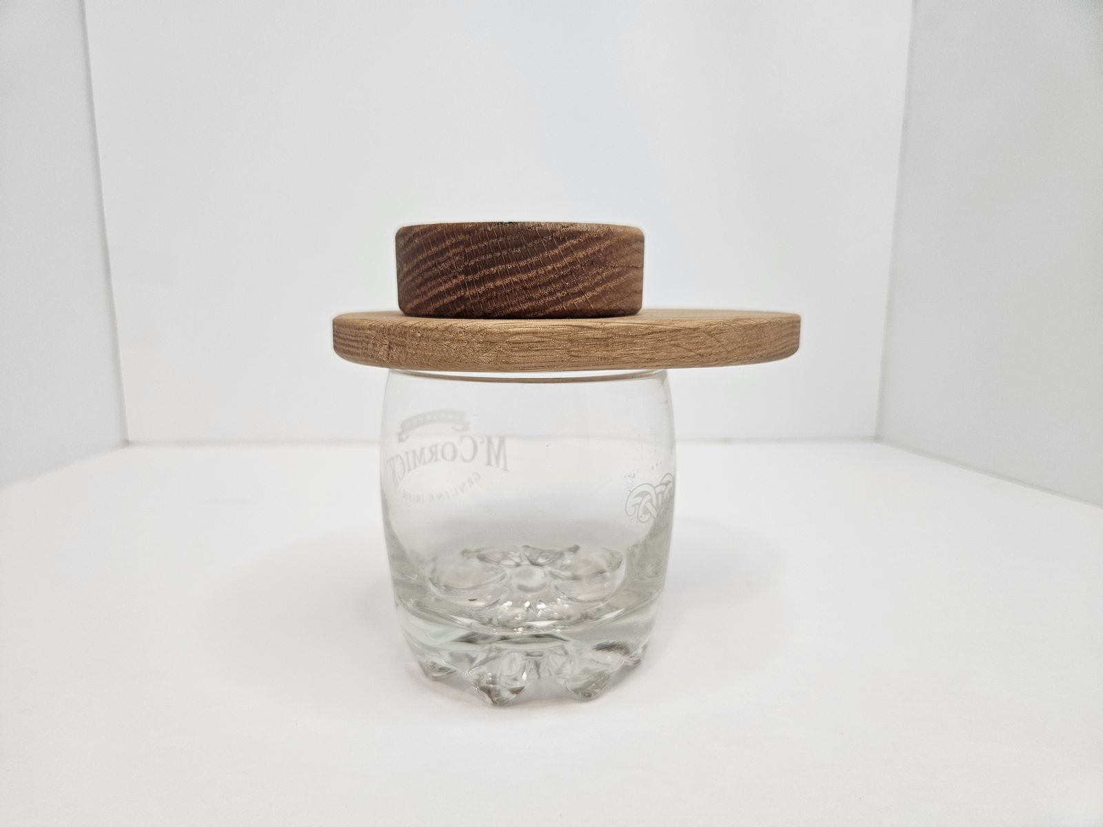 A single wooden whiskey smoker resting on a rocks glass